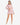 Model wearing pink waffle knit bell sleeve top and skirt set, styled for a casual yet chic look, studio background