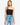 Model wearing black ribbed double-layer tube top, styled for a minimal, versatile look, studio background