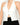 Model wearing off-white halter neck open-back top with buckle detail, styled for a sleek, modern look, studio background