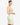 Model wearing sage sleeveless bustier tank top with sweetheart neckline and seam detailing, styled for a modern, structured look, studio background