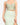 Model wearing sage sleeveless bustier tank top with sweetheart neckline and seam detailing, styled for a modern, structured look, studio background