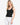 Model wearing ribbed double-layer V-neck tank top with body-hugging fit, styled for a minimal, sleek look, studio background