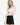 Model wearing off-white off-the-shoulder stretch lace top with long sleeves, styled for a chic, feminine look, studio background